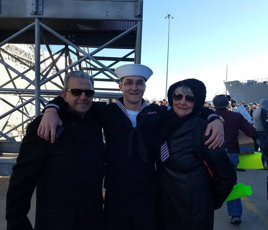 Carlo with his grandparents at a Navy ceremony